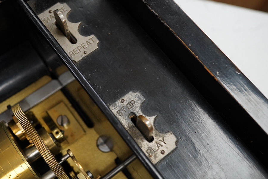 A late 19th century Swiss rosewood ten air cylinder music box, with inlaid lid decorated with musical instruments and foliage, paper label listing the airs to inside of lid, with sixty two tooth comb, cylinder 28cm, case